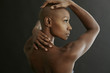 © Peathegee Inc/Blend Images - African American woman holding her bald head