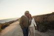 © Kyle Monk/Blend Images - Older Caucasian couple walking on dirt path
