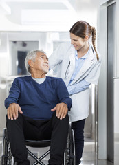 Canvas Print - Doctor Looking At Senior Patient On Wheel Chair