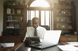 © John Fedele/Blend Images - Black doctor using digital tablet in office