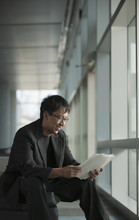 Asian Businessman Reviewing Paperwork
