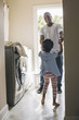 © Hello Lovely/Blend Images - African American father and daughter doing laundry