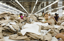 Workers Folding Clothing In Garment Factory