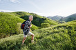 © Peathegee Inc/Blend Images - Older Caucasian man walking on grassy hillside