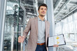 © Drobot Dean - Happy businessman with business plan entering the door in office