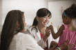 © John Fedele/Blend Images - Doctor handing girl lollipop
