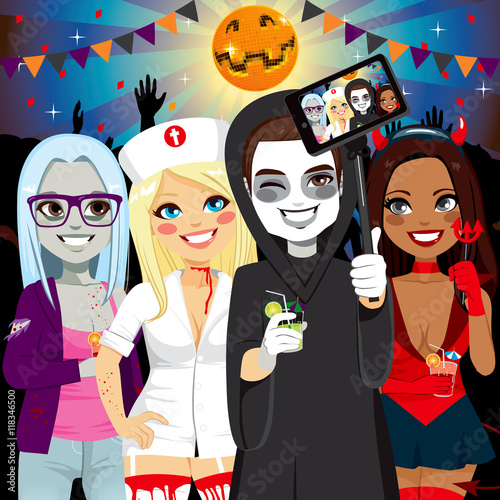 Small group of young adult people on Halloween costume party taking selfie