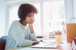 © baranq - Bored female student looking at laptop studying from home