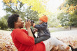 © Jasper Cole/Blend Images - Black mother taking pictures of toddler son in park