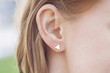 Woman ear wearing beautiful luxury earring