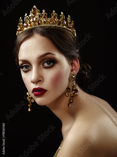 Cuadros en Lienzo Hermosa chica morena con una corona de oro, aretes y profes