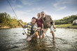 © John Fedele/Blend Images - Three generations of Caucasian men fishing in river