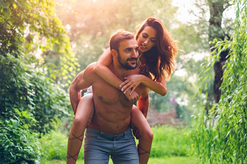 Wall Mural - Man carrying his girl in nature