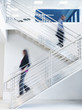 © Erik Isakson/Blend Images - Blurred view of business people climbing office staircase