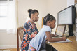 © Hello Lovely/Blend Images - African American mother with daughter working from home