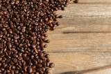 Fototapeta Kuchnia - Coffee beans on wooden container wood on a wooden background