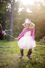 Girl Playing Princess In Backyard