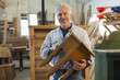 © Marc Romanelli/Blend Images - Hispanic craftsman smiling in studio