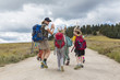 © Marc Romanelli/Blend Images - Caucasian hiker leading children on path in remote landscape