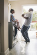© Hello Lovely/Blend Images - African American father and daughter doing laundry
