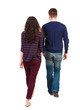 © ghoststone - Back view going couple. walking friendly girl and guy holding hands. Rear view people collection. backside view of person. Isolated over white background. Swarthy girl and the bearded man into the