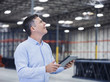 © Erik Isakson/Blend Images - Caucasian businessman using digital tablet in empty warehouse