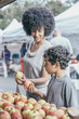 © Inti St Clair/Blend Images - Mixed race boy shopping with mother at farmers market