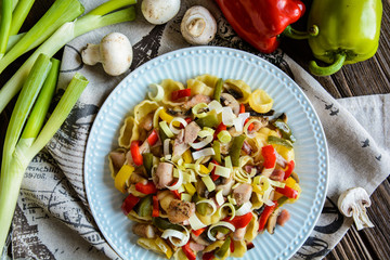 Wall Mural - Pasta salad with backed chicken breast, fried bacon, pepper, mushrooms and leek