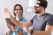 © zinkevych - Cheerful colleagues testing virtual reality glasses