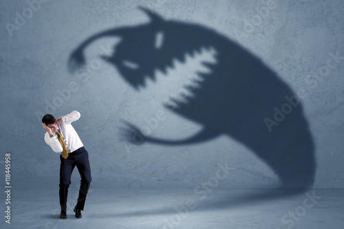 Fotomural Business man afraid of his own shadow monster concept