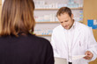 © contrastwerkstatt - mann berät eine kundin in der apotheke