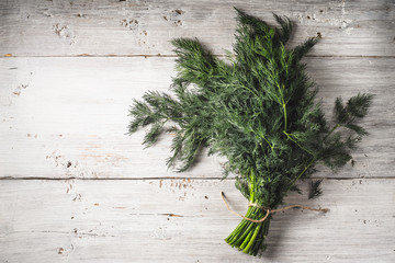 Wall Mural - Bunch of dill on the white wooden table horizontal