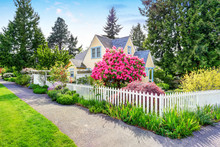 Small Yellow House Exterior With White Picket Fence