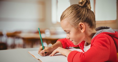 Sticker - Composite image of cute girl writing in a book