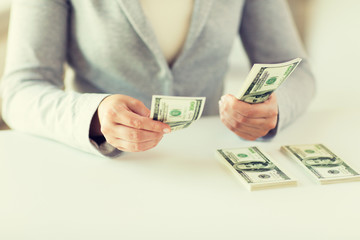 Poster - close up of woman hands counting us dollar money