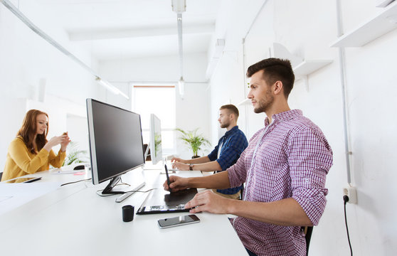 man or designer with computer and tablet at office