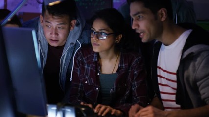 Wall Mural -  Team of young computer hackers trying to gain access to a computer system