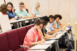 © Syda Productions - group of students with notebooks in lecture hall
