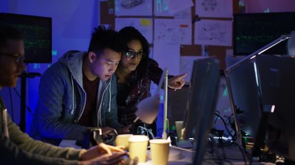 Wall Mural -  Team of young computer hackers trying to gain access to a computer system