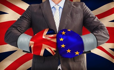 Poster - Composite image of businessman with boxing gloves