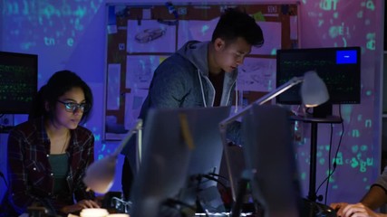Wall Mural -  Team of young computer hackers trying to gain access to a computer system