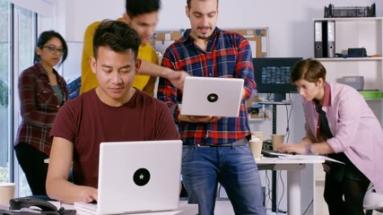 Wall Mural -  Time lapse of young computer experts working in office with lots of computers