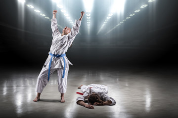 Sexy girl in a kimono karate rejoices victory