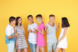 © Africa Studio - Happy teenagers on yellow background