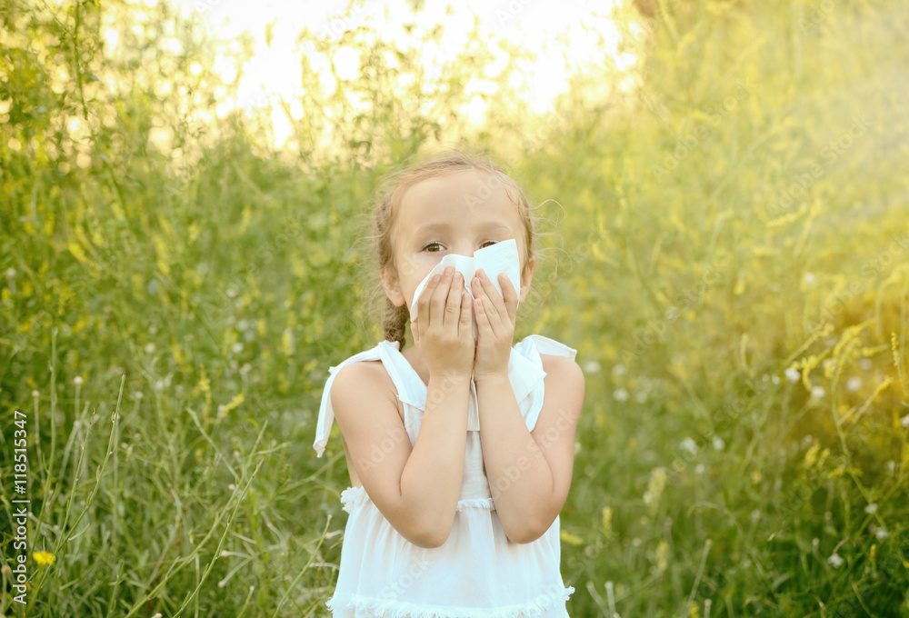 Little girl with handkerchief in field