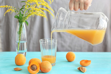 Poster - Woman pouring apricot juice in glass