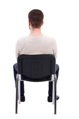 back view of business man sitting on chair.  businessman watching. Rear view people collection.  backside view of person.  Isolated over white background. The bearded man in a white warm sweater sits