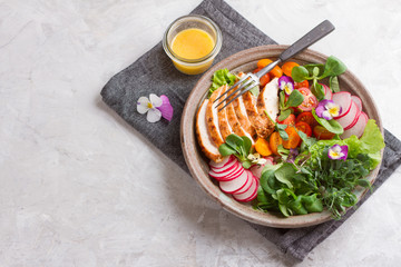 Wall Mural - Spring salad with vegetables, chicken breast and edible flowe