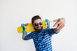 © kegfire - bearded hipster taking selfie with smartphone