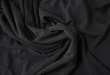 A full page close up of soft black cotton material texture